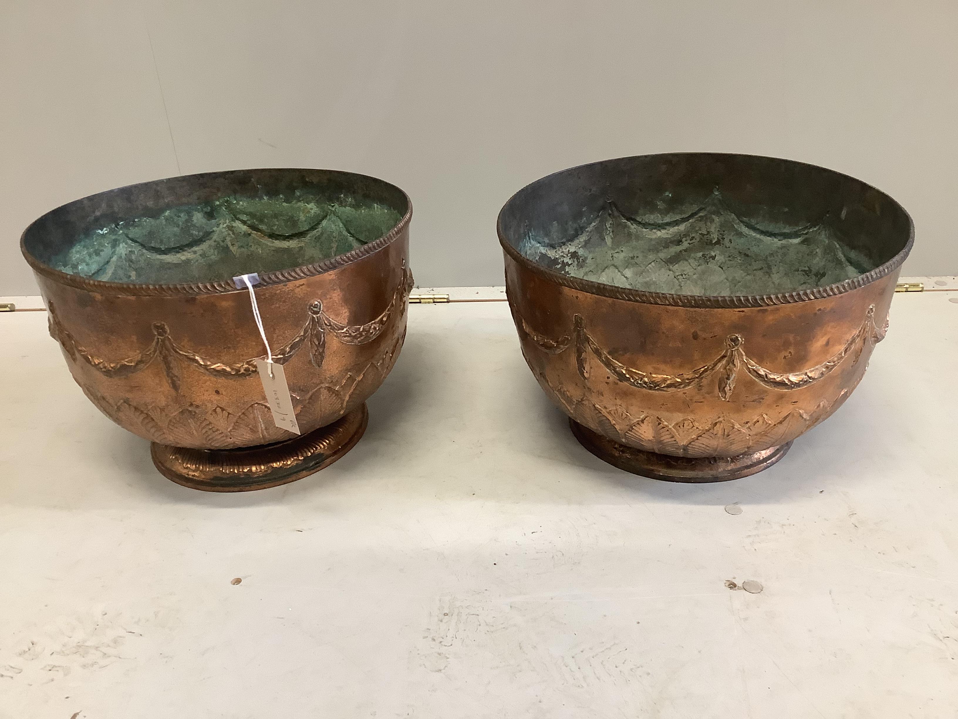 A pair of circular embossed copper bowls, diameter 39cm, height 27cm